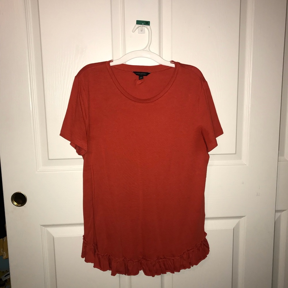 orange frilly shirt
